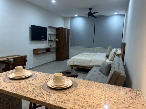 a living room with a table with hats on it at Solum Luxury Condos in Tulum