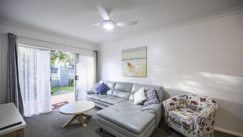 a living room with a couch and a table at Apartment 27 - The Meridian in Old Bar