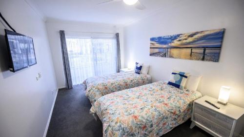 a bedroom with two beds and a window at Apartment 27 - The Meridian in Old Bar