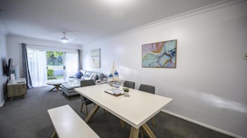 a living room with a table and a couch at Apartment 27 - The Meridian in Old Bar