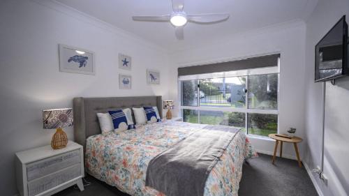 a bedroom with a bed and a window at Apartment 27 - The Meridian in Old Bar