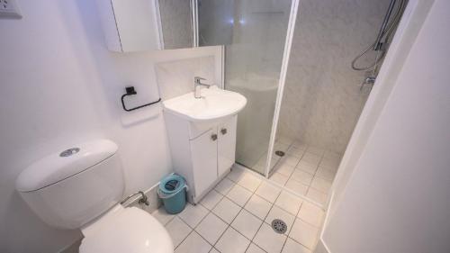 a bathroom with a toilet and a sink and a shower at Apartment 27 - The Meridian in Old Bar