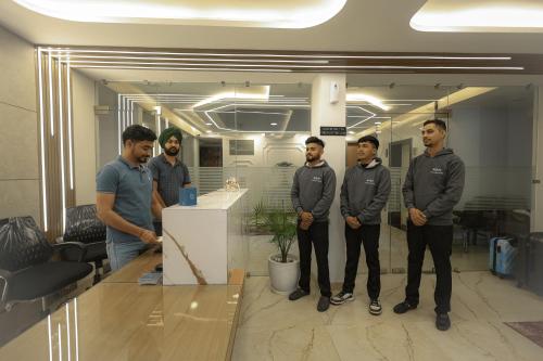a group of men standing in an office at Arjun - A boutique hotel in Haridwār