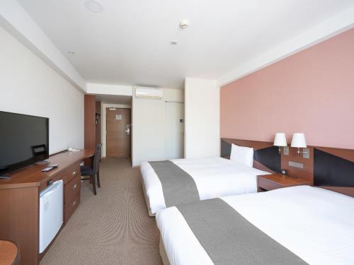 Postel nebo postele na pokoji v ubytování Vessel Hotel Kanda Kitakyushu Airport