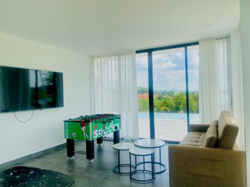 a living room with a couch and a table at Du Lịch Lâm Hà - Hồ Gia Trang Villas in Lam Ha