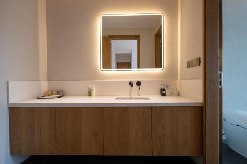 a bathroom with a sink and a mirror at Hidden Travel Shenzhen Dapeng in Dapeng