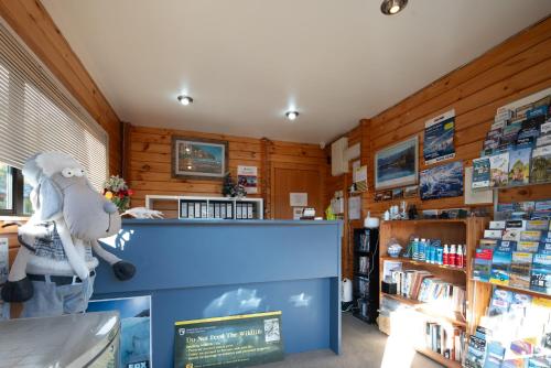 a shop with a stuffed bird on the counter in a store at Fox Glacier Lodge in Fox Glacier