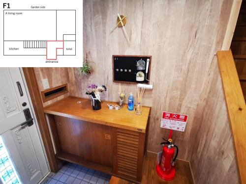 a small desk in a room with a wall at 100泊で完成する民泊 in Takamori