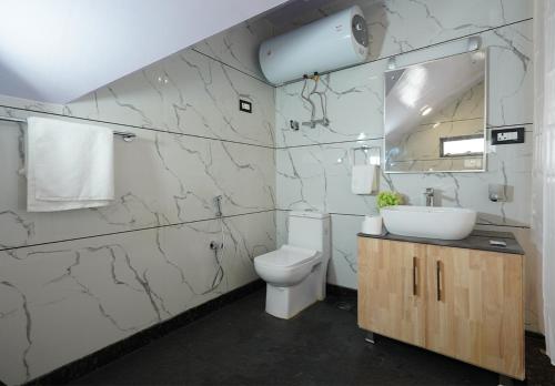 a bathroom with a toilet and a sink at Moustache Srinagar in Srinagar