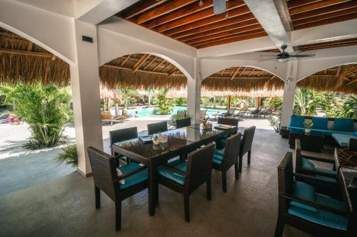 a dining room with a table and chairs at Secret paradise moalboal in Moalboal