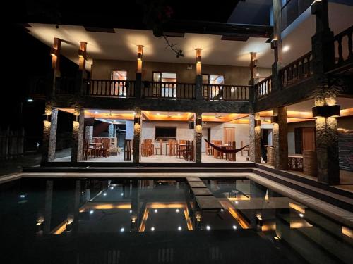 a house with a swimming pool at night at Tabularasa - T Palawan in San Vicente