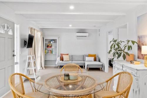 a living room with a table and chairs and a couch at The Cottage- Pet friendly, Golf, Ocean and River! in Ocean Grove