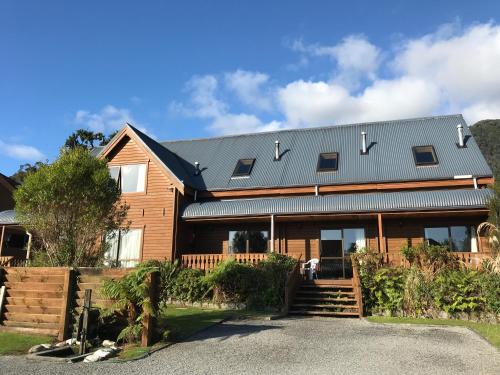 a house with a metal roof on top of it at Fox Glacier Lodge in Fox Glacier