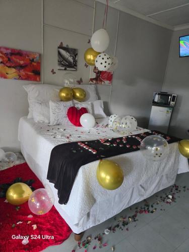 a bedroom with a bed with lots of balloons on it at DREAMLAND GUEST HOUSe in Mahikeng