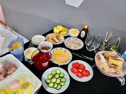 a table with many plates of food on it at SapzRes at Klerksdorp in Klerksdorp