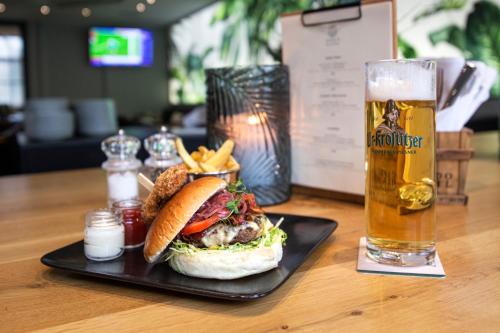 a sandwich and french fries and a glass of beer at Parkhotel Diani in Leipzig