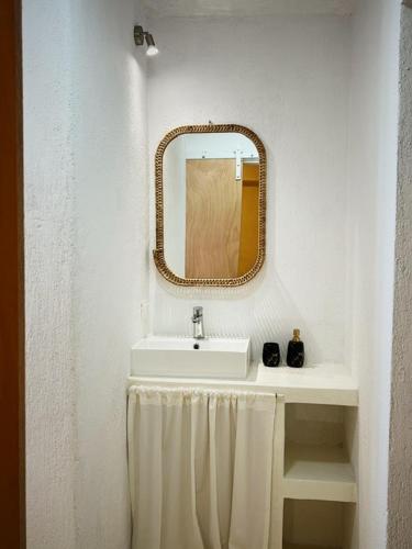 a bathroom with a sink and a mirror at Sand&Sea in Neo Klima
