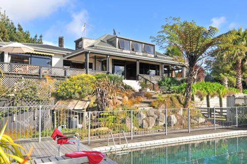 a house with a pool in front of it at Warwick Hills Rural Bed & Breakfast in Papamoa