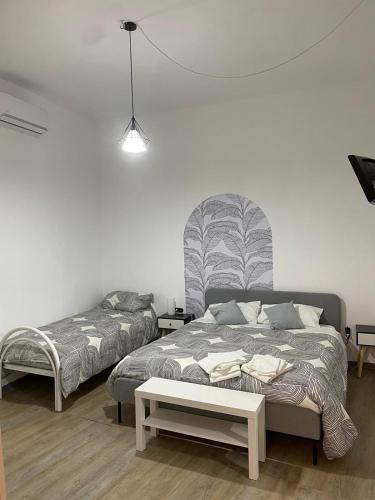 a bedroom with a bed and a table in it at Aria di sale in Trapani