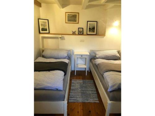 Voodi või voodid majutusasutuse The little thatched cottage toas
