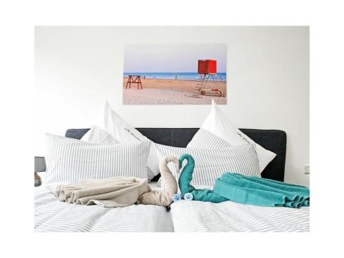 a bed with towels on it next to a beach at Old Printing House Holiday Apartment Gutenberg in Norderney