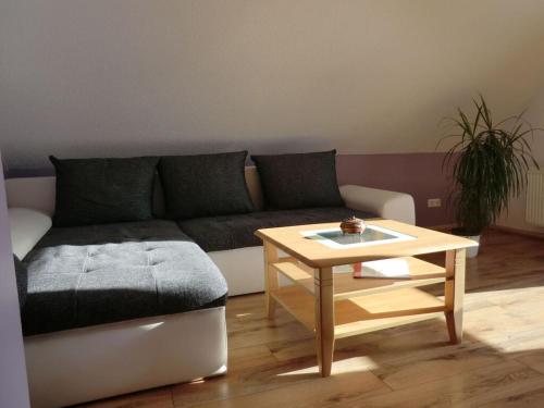 a living room with a couch and a table at Schwalbennest Comfortable holiday residence in Perrich