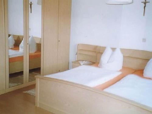 a bedroom with two beds and a mirror at Family- friendly apartment in bavarian forest in Prackenbach