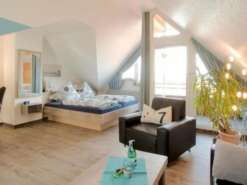 a living room with a bed and a couch at Lüerßen directly by the sea apartment 7 in Steinhude