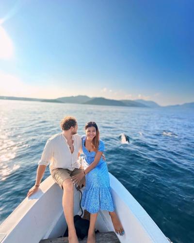 a man and a woman sitting on a boat in the water at The Hawk's Nest Resort in Sabong
