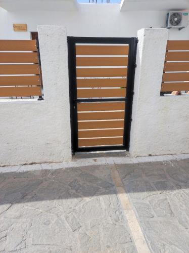 two doors on the side of a building at Giorgio studios II in Kokkari