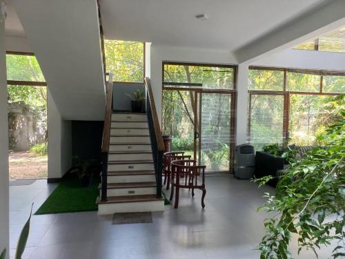 a living room with a staircase in a house at Gampaha Heritage in Gampaha