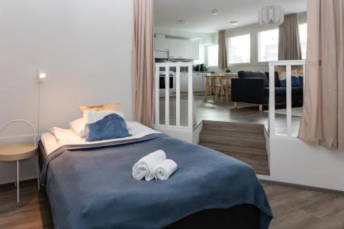 a bedroom with a bed with two towels on it at Forenom Serviced Apartments Lahti Hennala in Lahti