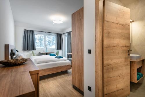 Postel nebo postele na pokoji v ubytování T-Lodge Zauchensee