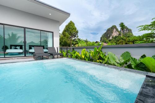 a swimming pool in the backyard of a house at Sea Eagle Mountain private pool villa Aonang in Ban Nong Thale