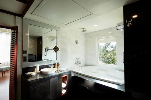 a bathroom with a large tub and a sink at Heritance Ahungalla in Bentota
