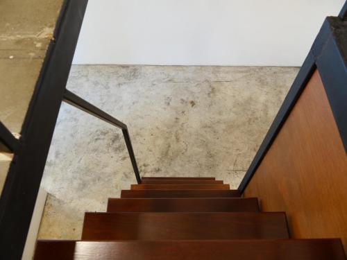 a staircase in a building with wooden stairs and a wall at Book a Bed Poshtel - SHA Plus in Phuket Town