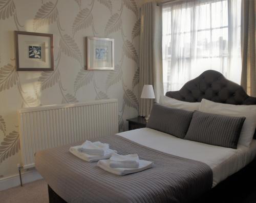 a bedroom with a bed with two towels on it at Star Inn Hotel in Upton upon Severn