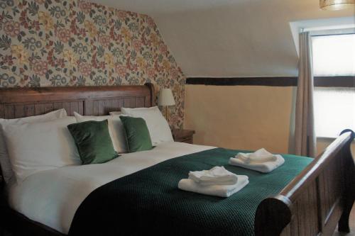 a bedroom with a bed with two towels on it at Star Inn Hotel in Upton upon Severn