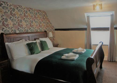 a bedroom with a bed with two towels on it at Star Inn Hotel in Upton upon Severn
