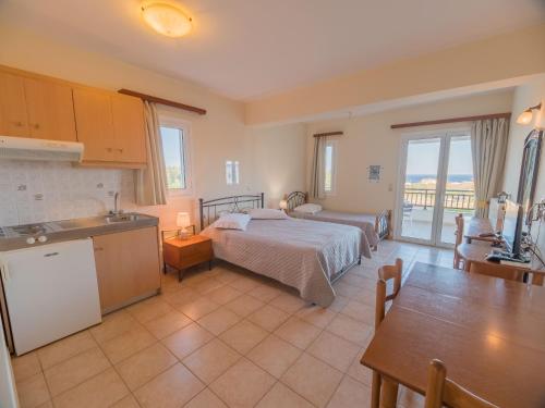 a kitchen and a bedroom with a bed in a room at Apartments Hotel & Studios, Xifoupolis in Monemvasia