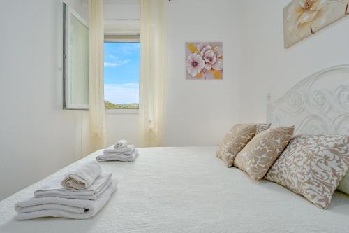 a bedroom with a bed with towels on it at La Casetta Bianca in Loiri