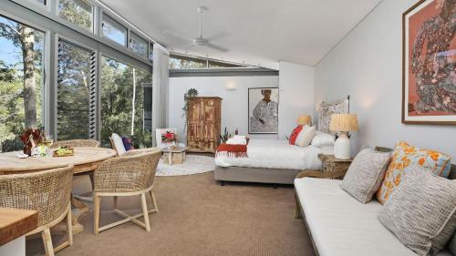 a living room with a bed and a table at Saltwater Creek in Bundannon