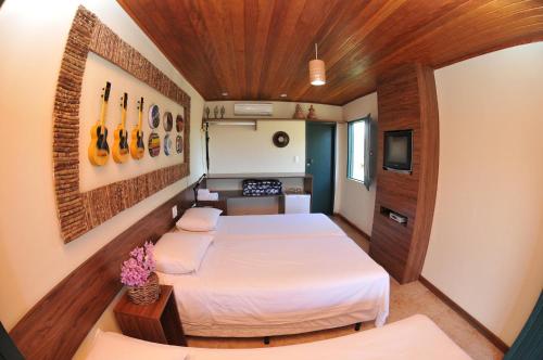 Tempat tidur dalam kamar di Pousada Fazenda Santa Fe