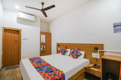 a bedroom with a bed and a ceiling fan at FabExpress Anurag Residency in Guwahati