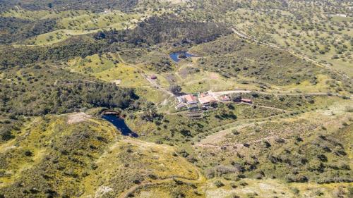 an aerial view of a mountain with a house on it at Quinta Marugo Retreats in Serpa