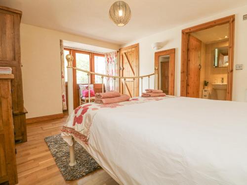a bedroom with a large white bed in a room at Mill in Porthleven