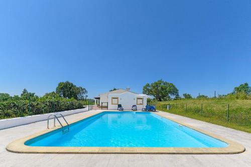 a swimming pool in front of a house at Monte do Cerro Verde in Santiago do Cacém