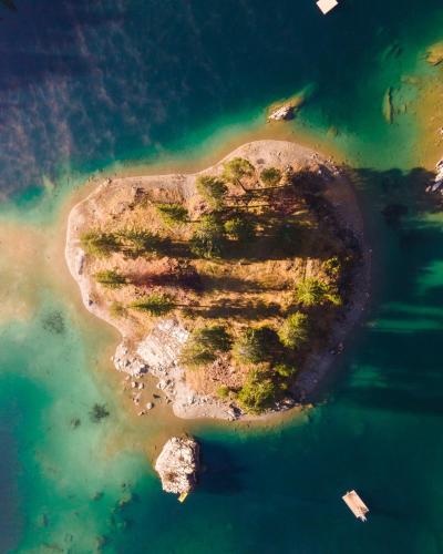 an aerial view of an island in the water at VISIMO Apartments Flims with private Sauna in Flims