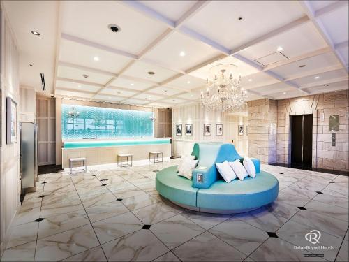 a living room with a blue couch in the middle at DEL style Nagoya Nayabashi by Daiwa Roynet Hotel in Nagoya