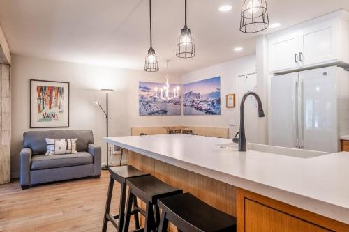 a kitchen with a large sink and a couch at Fully Renovated! St Anton #17 Ski in Ski Out 1 Bedroom 1 Bathroom Condo! Sleeps up to 4! in Mammoth Lakes